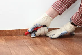 Verlegung - Bodenleger schneider PVC-CV Belag mit einem Cutter Messer passend zur Wand