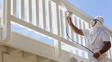 House Painter Spray malen ein Deck, zu Hause zu sein - Stock-Fotografie